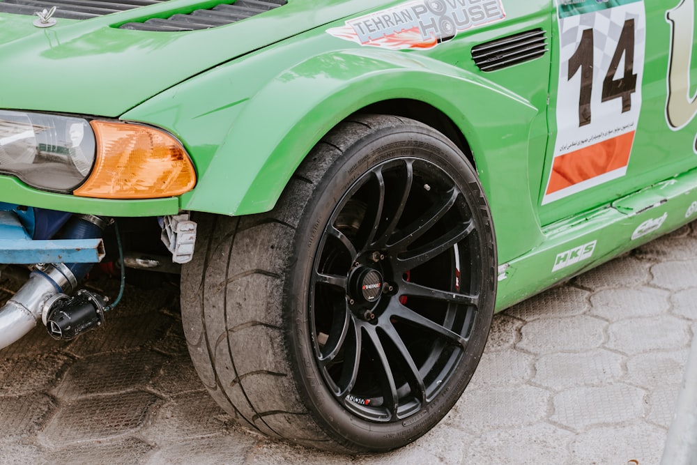 green car on gray concrete floor