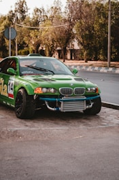 green chevrolet camaro on road during daytime