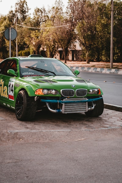 green chevrolet camaro on road during daytime