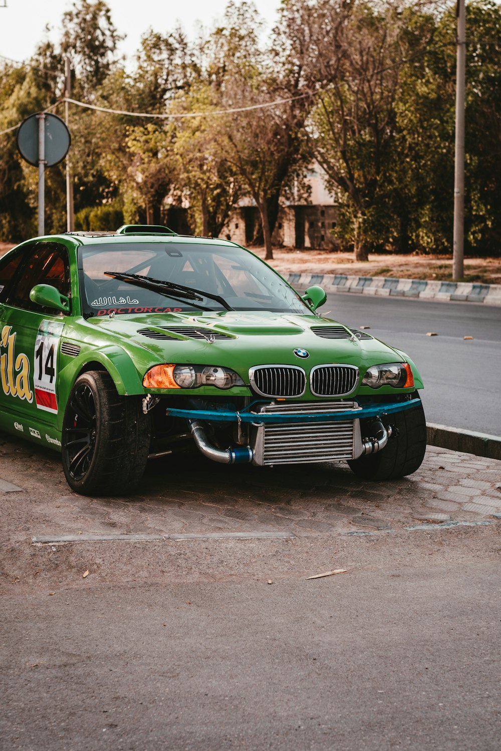 green chevrolet camaro on road during daytime