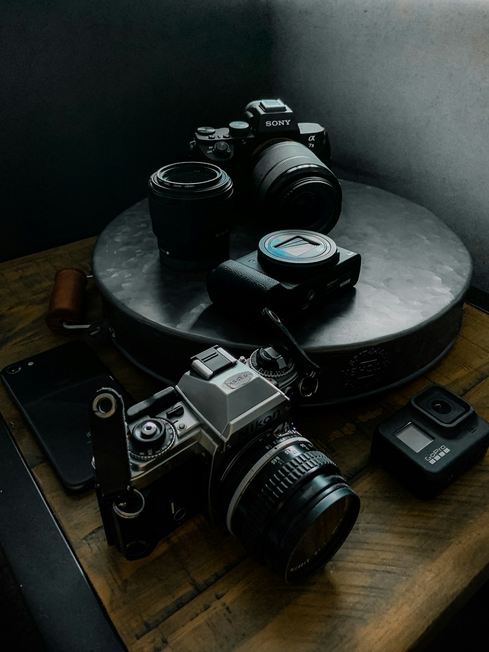 black and silver dslr camera beside black camera