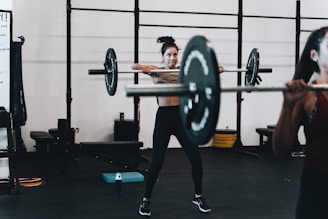 woman in black leggings and black tank top doing exercise