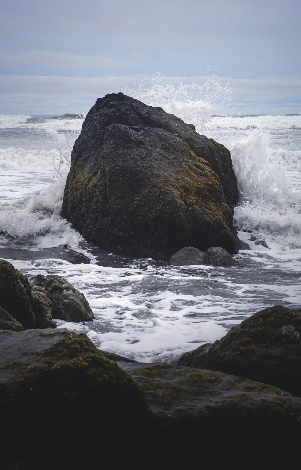 brown rock formation on sea water during daytime