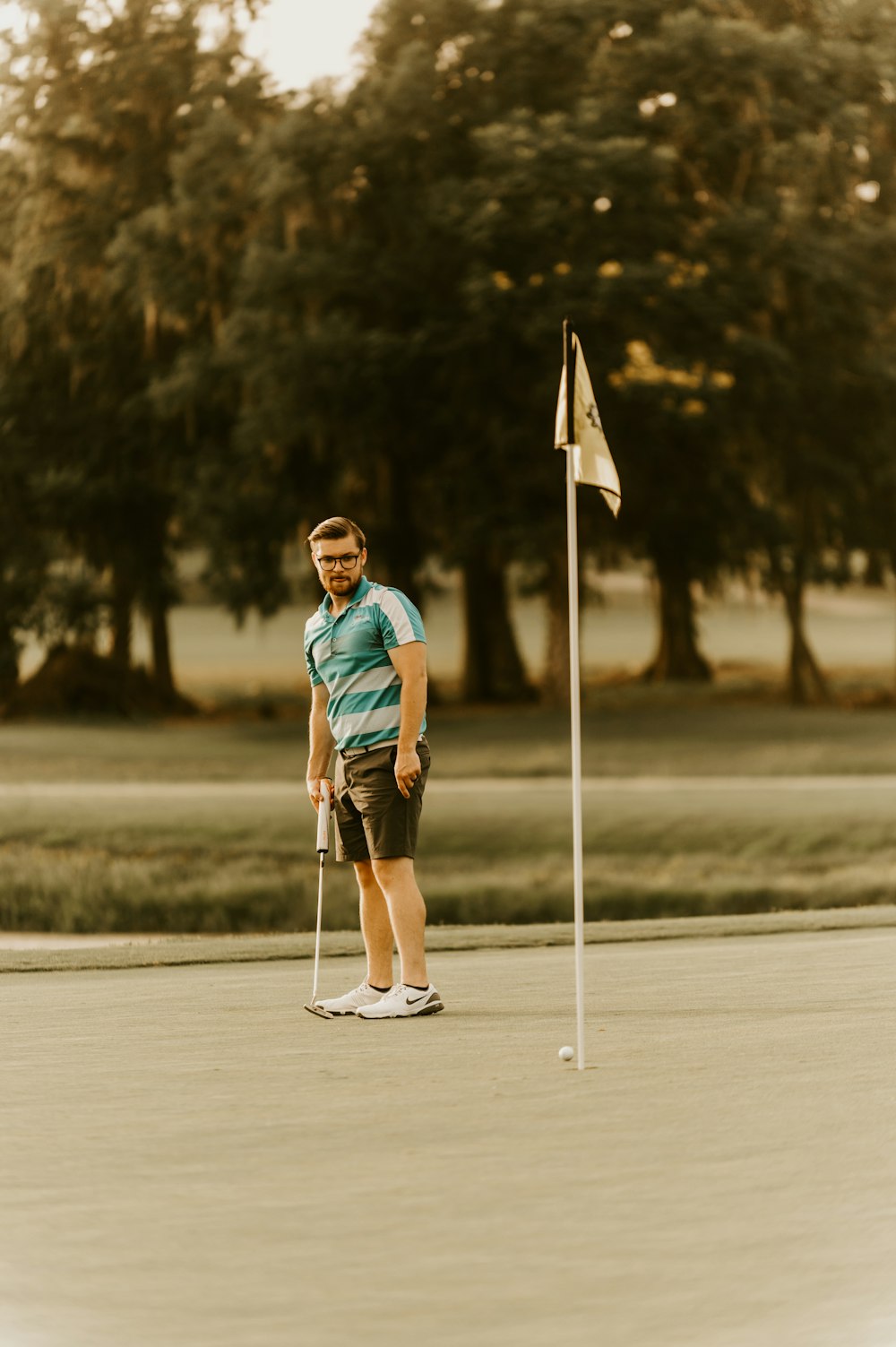 woman in blue and white shirt holding white and yellow flag