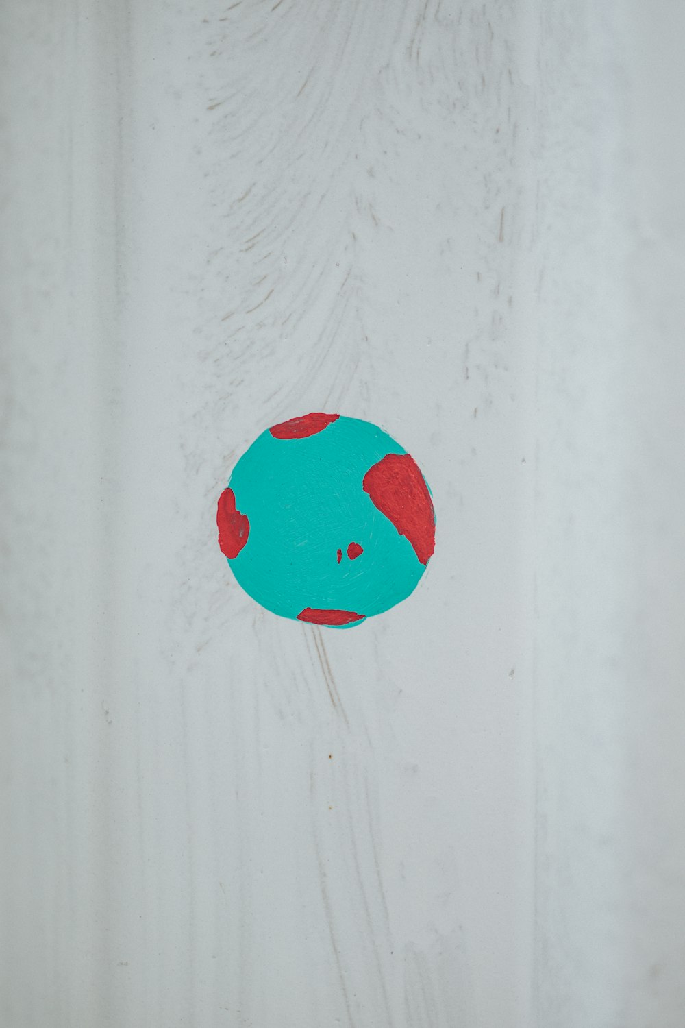 red round ornament on white wall