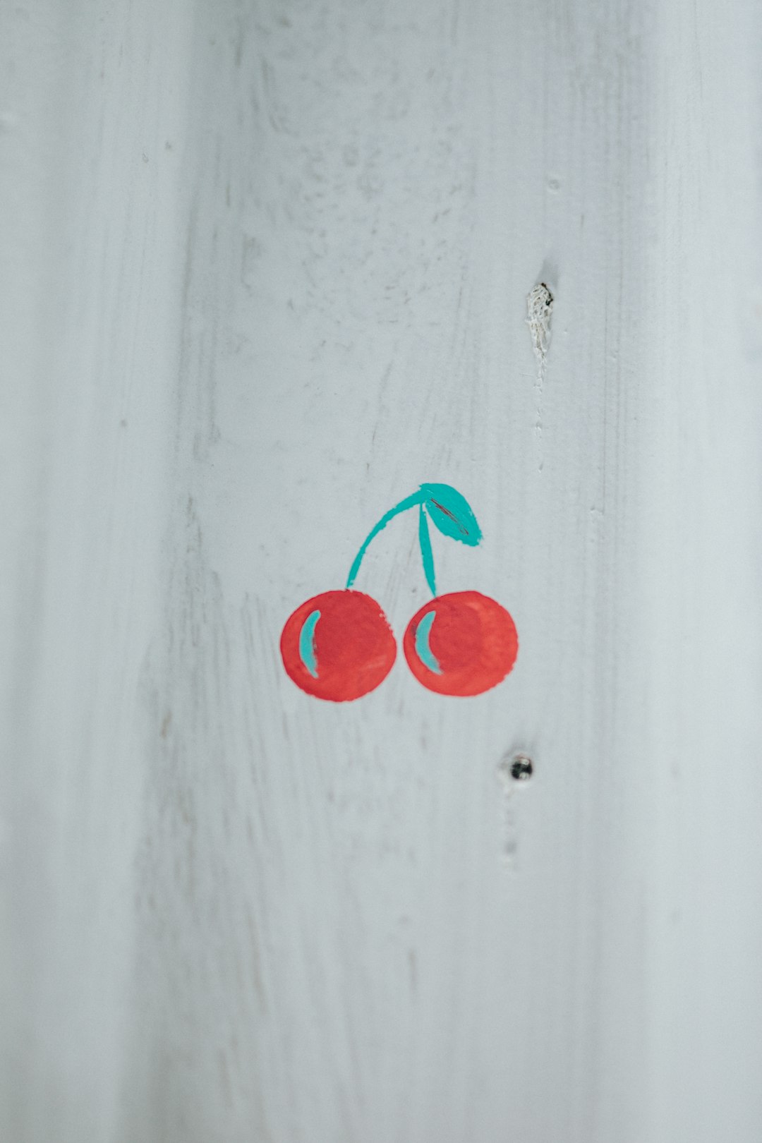 red heart on white wooden surface