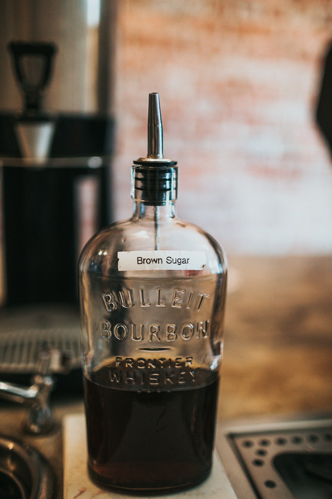 clear glass bottle with black liquid inside