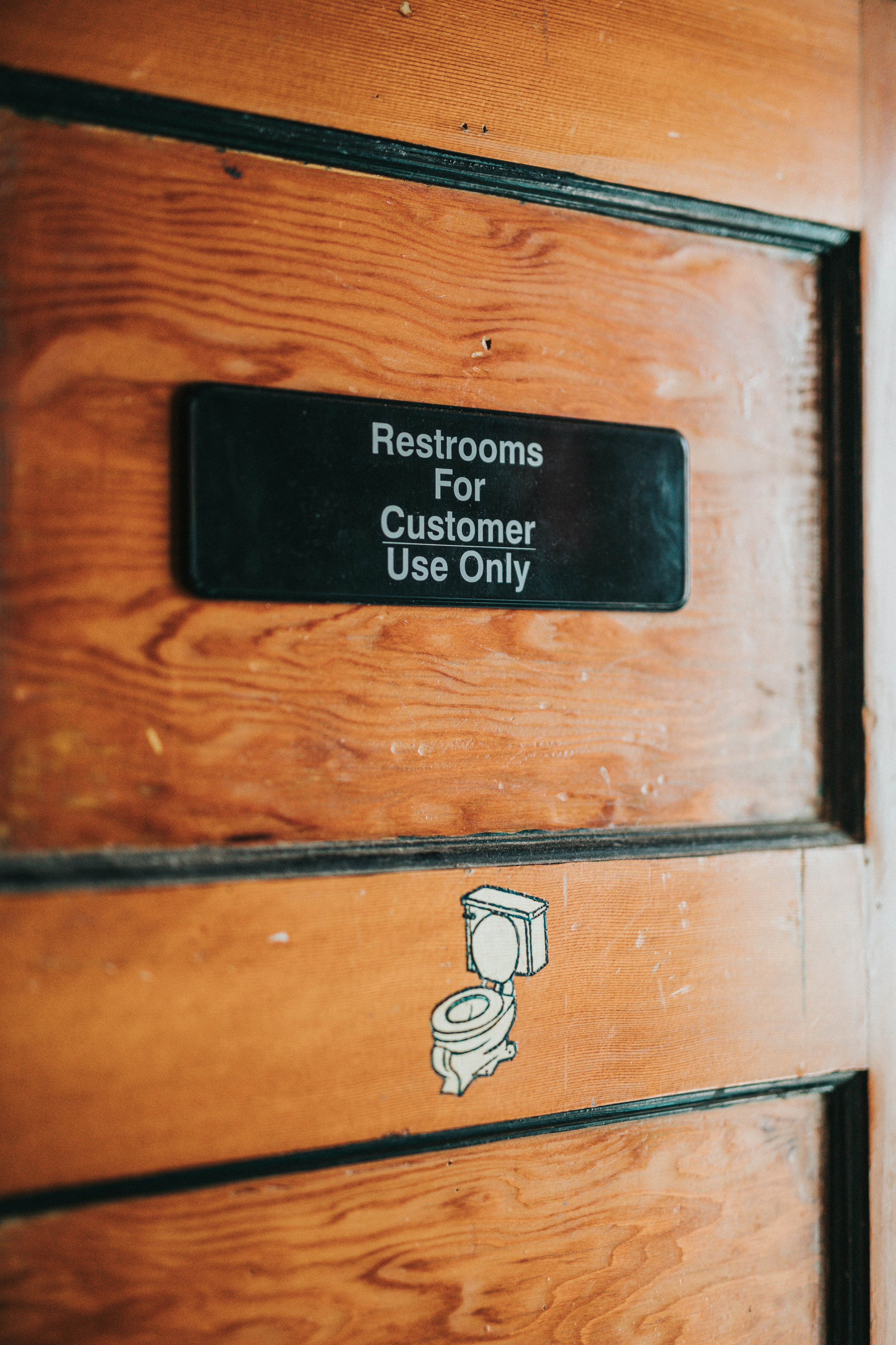 brown wooden door with black and white sticker