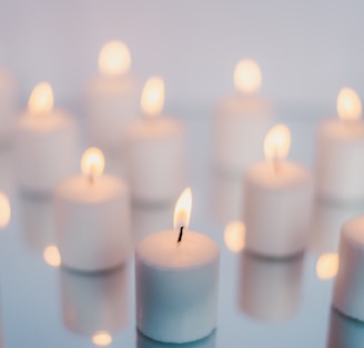 white candles on brown wooden table