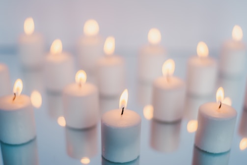 white candles on brown wooden table