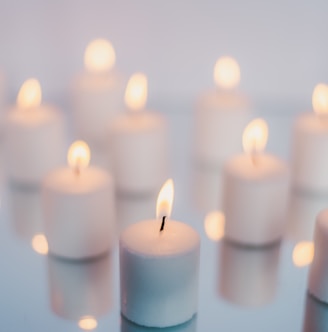 white candles on brown wooden table