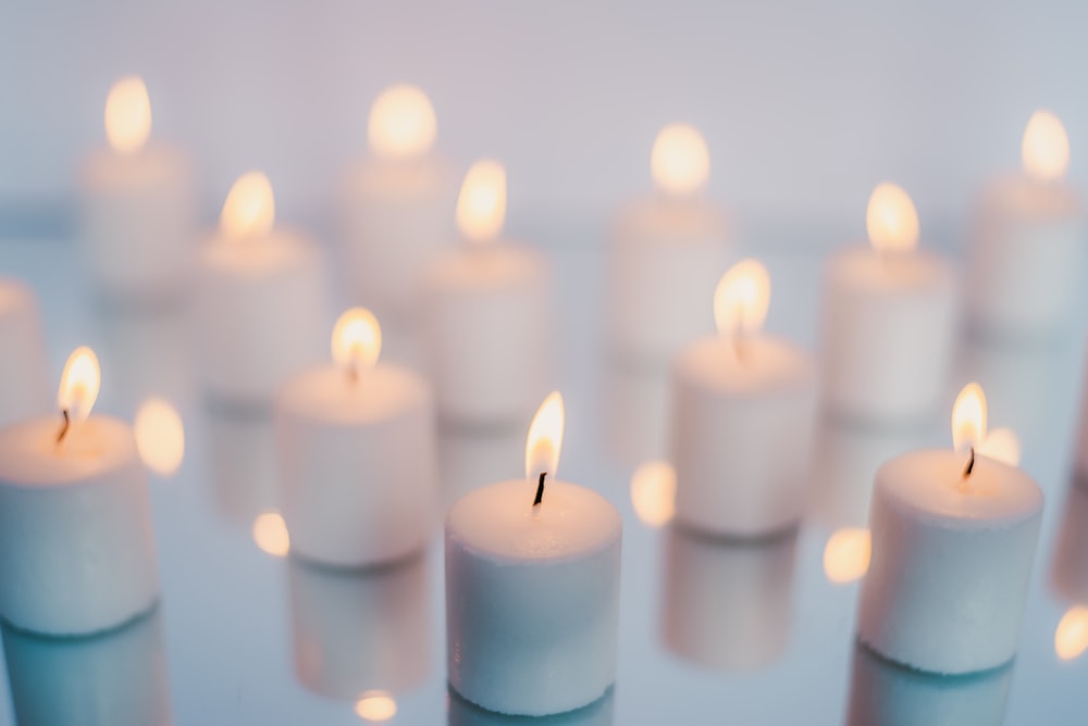 white candles on brown wooden table