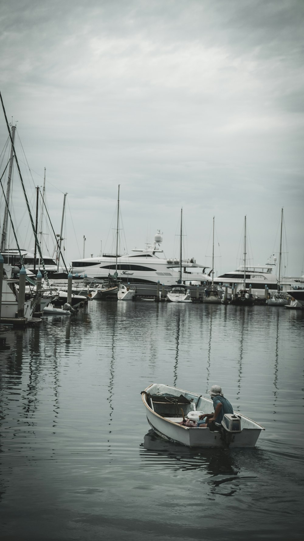 man in red shirt sitting on boat during daytime