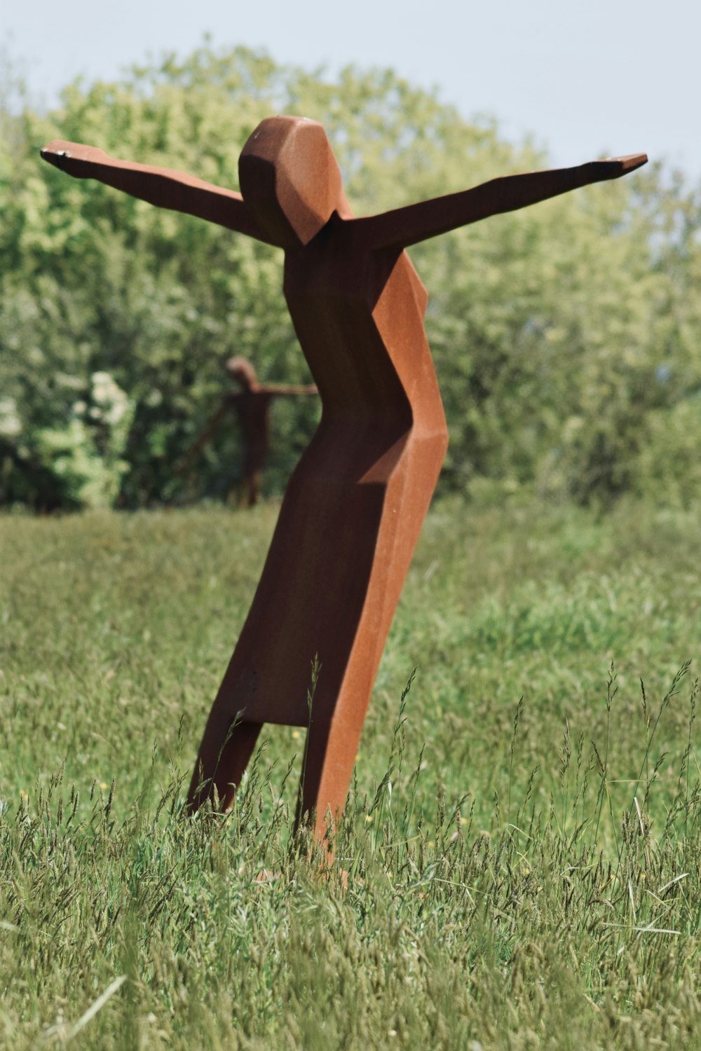 brown wooden stand on green grass field during daytime