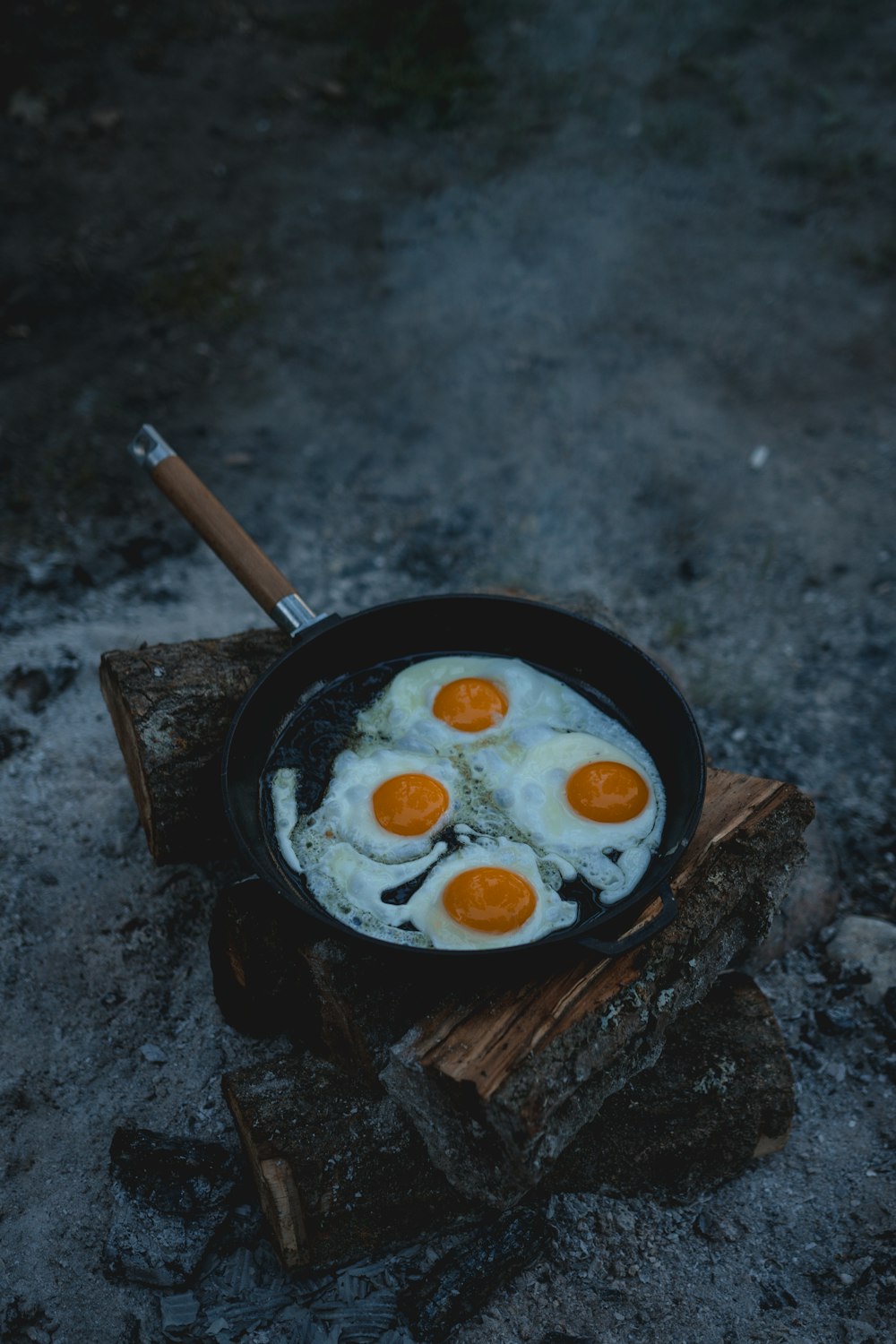 black frying pan with white cream and brown wooden stick