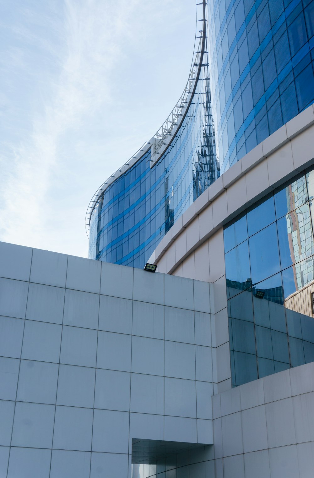 white and blue concrete building under white clouds during daytime