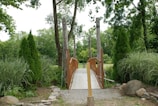 A peaceful footpath crossing a small wooden bridge over a bubbling creek.