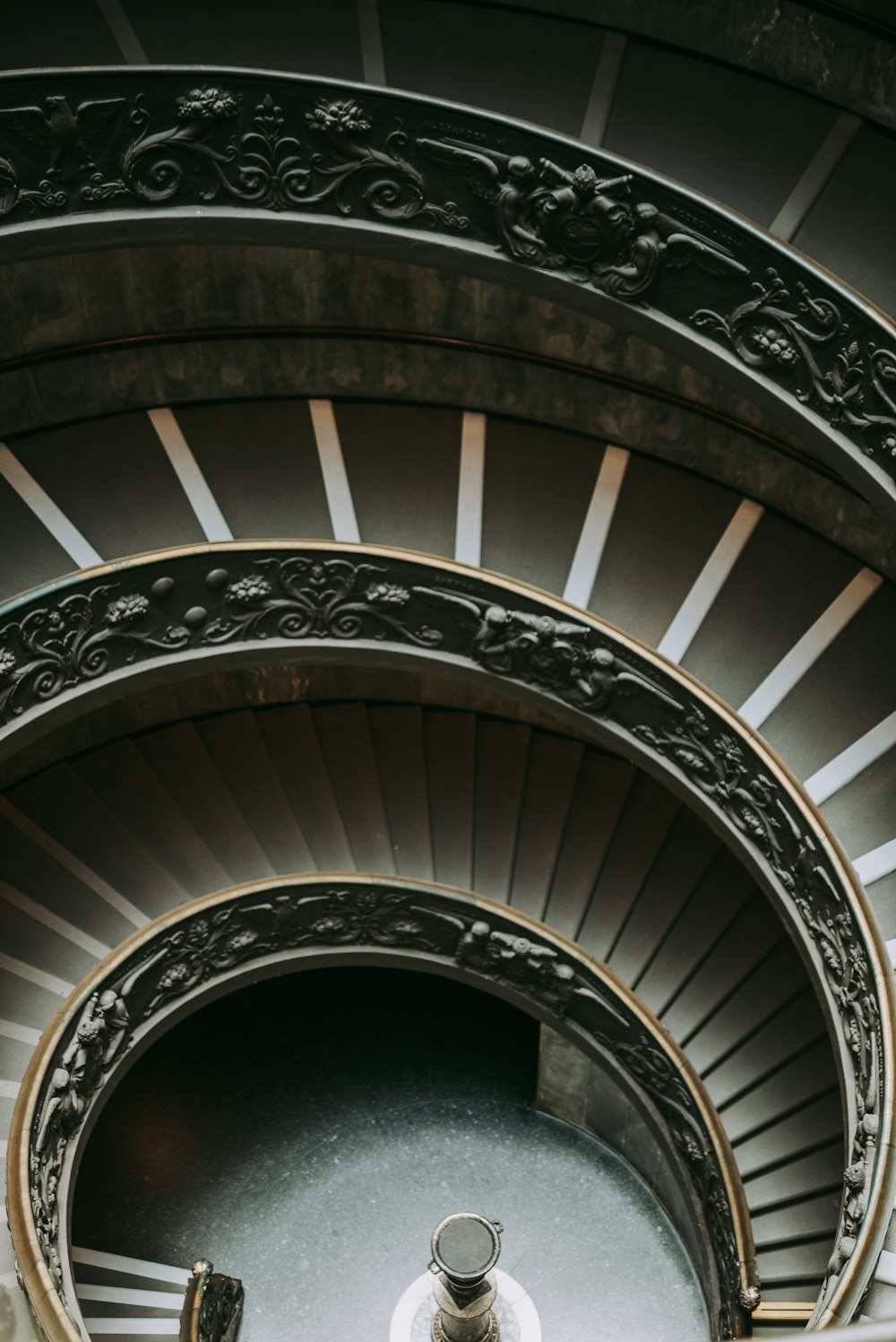 brown wooden spiral staircase with white wooden railings