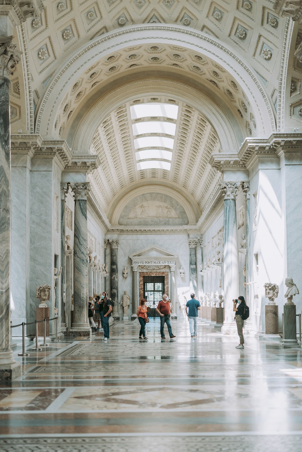 people walking inside white concrete building