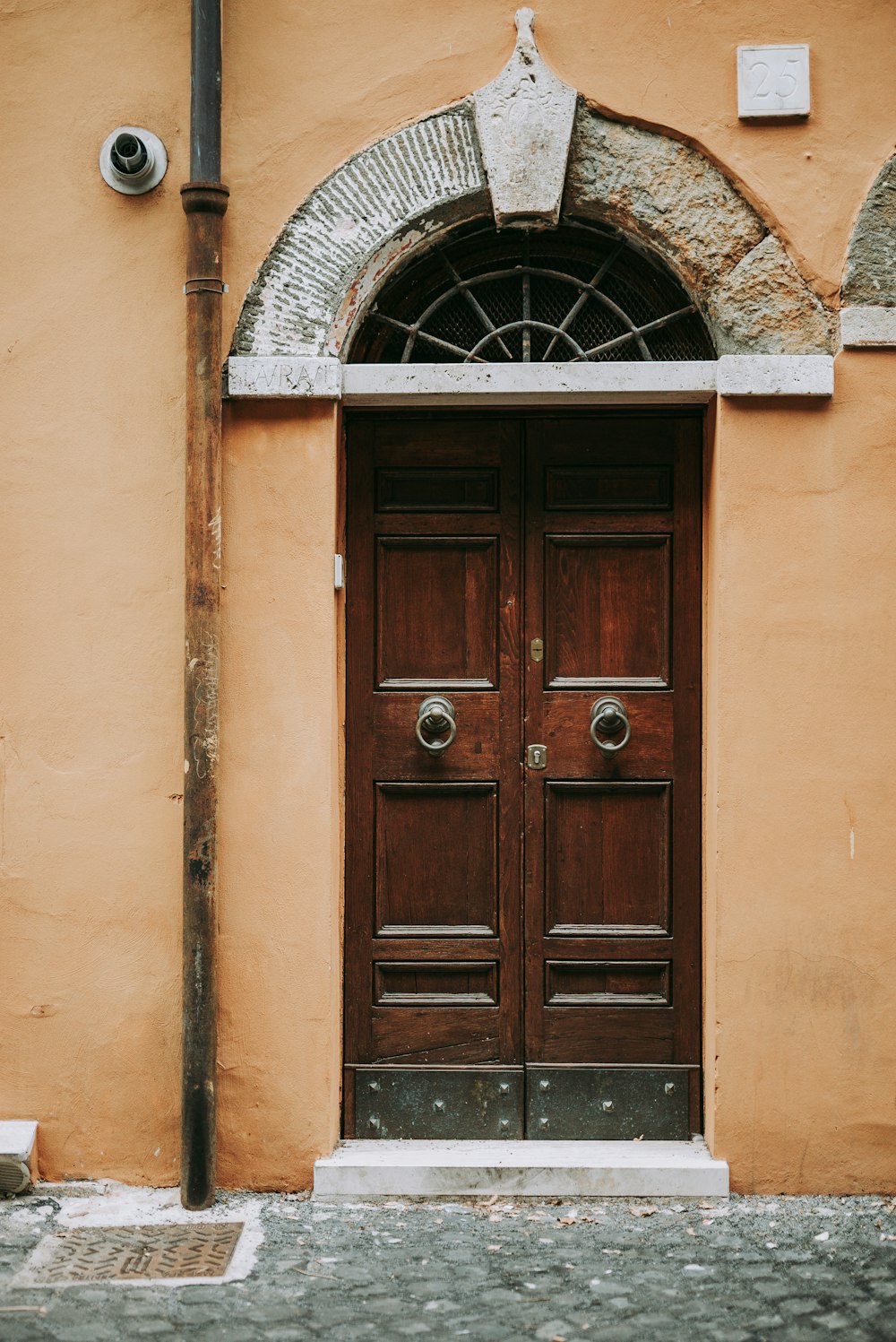 brown wooden door on beige concrete building