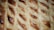 A close-up of a delicate pastry with intricate details and a glossy finish.