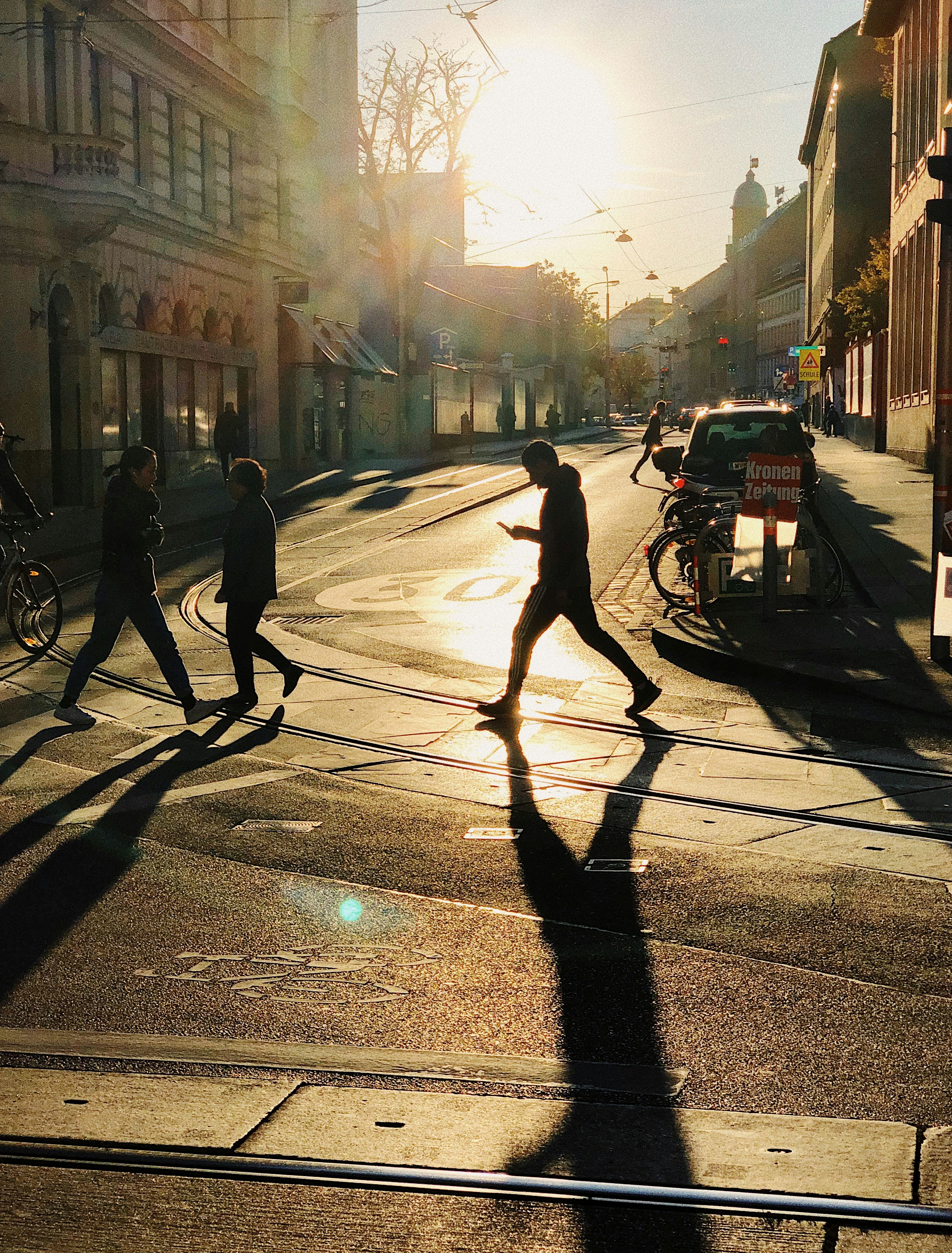 man and woman walking on sidewalk during daytime