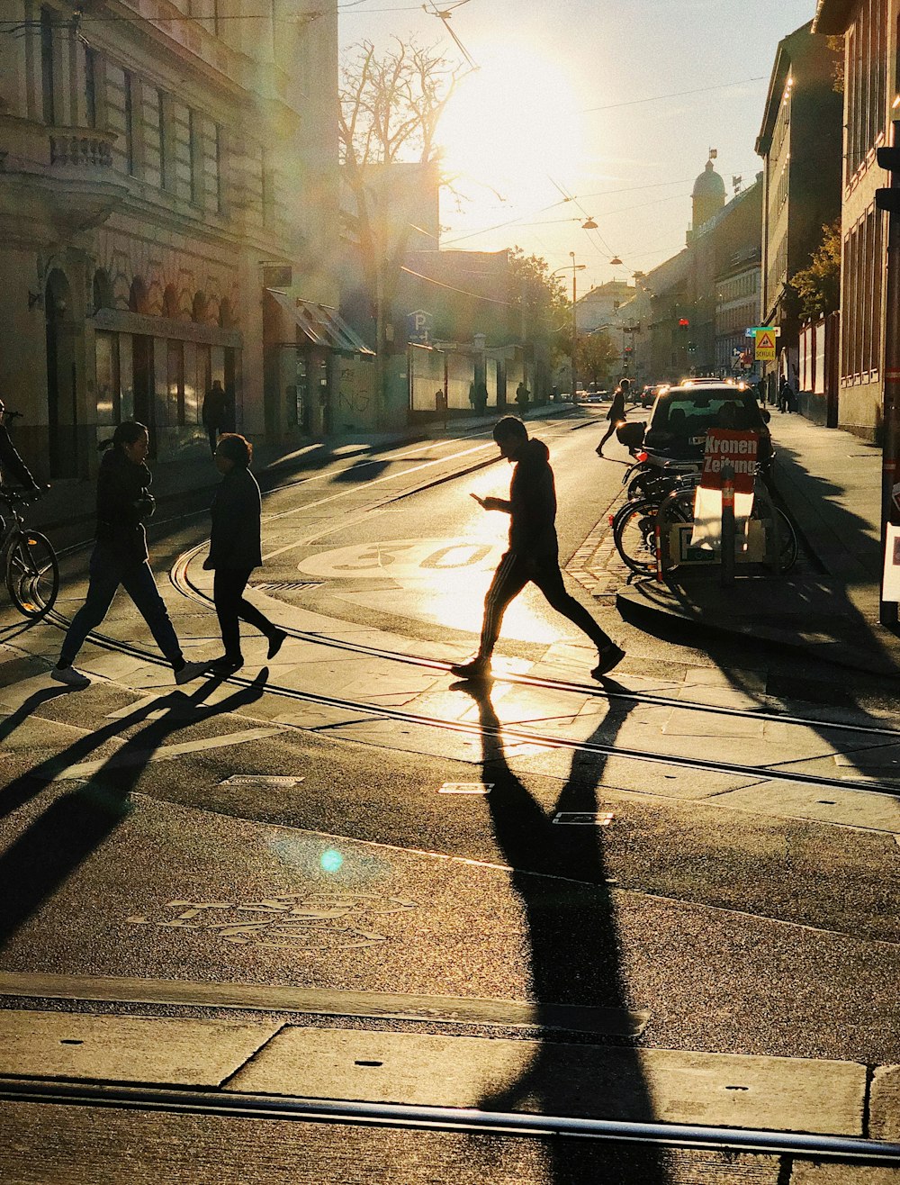 man and woman walking on sidewalk during daytime