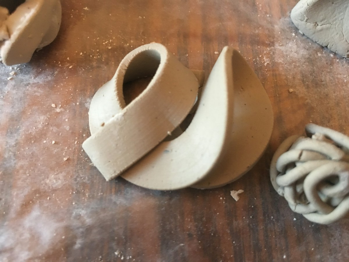 White ceramic figurine on a wooden table, symbolizing unity and creativity in team building activities for teachers.