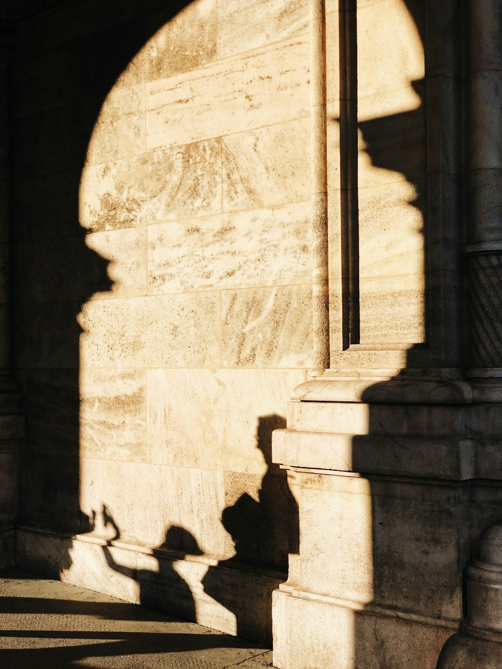 silhouette of people standing near concrete building during daytime