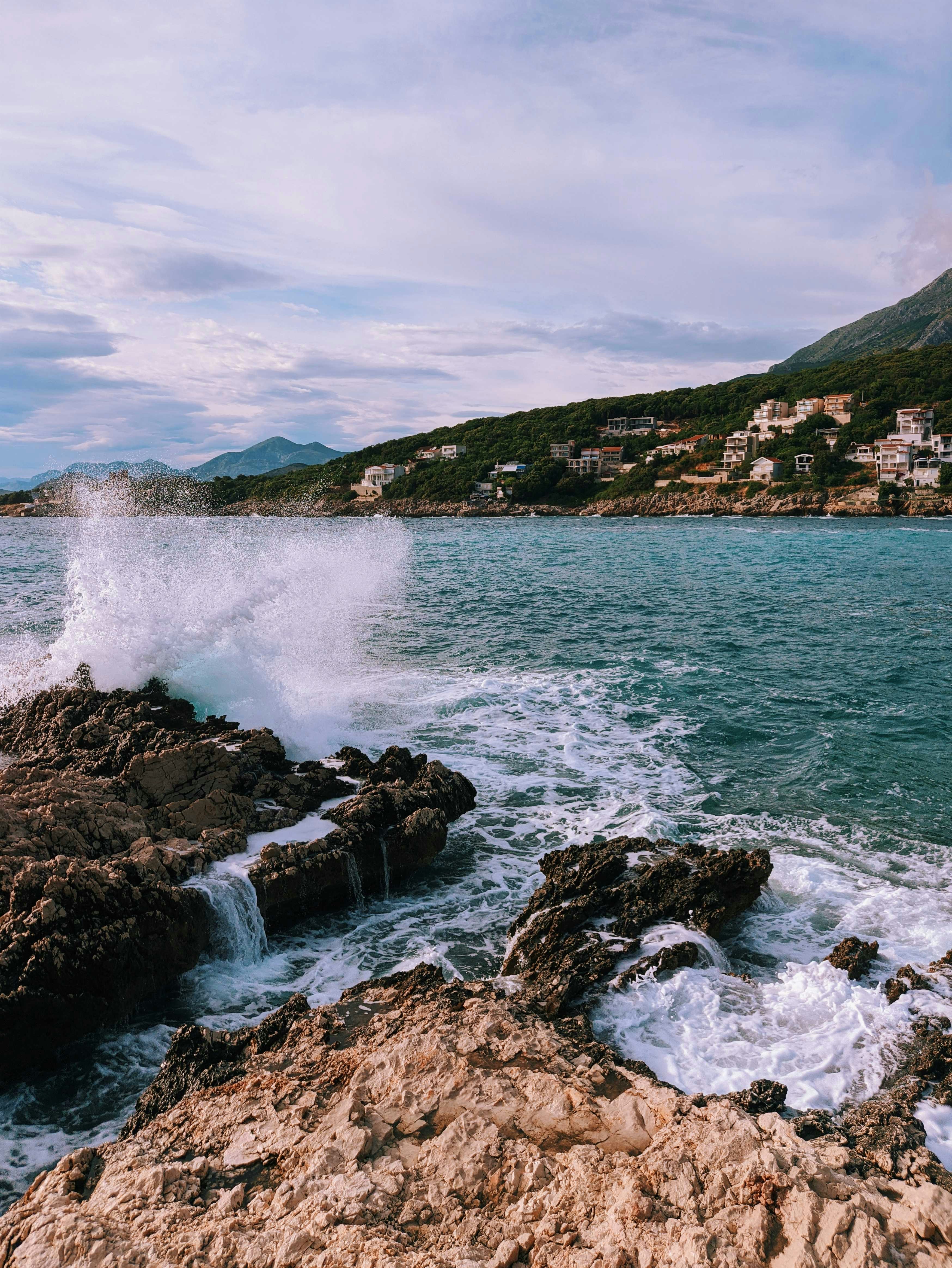 brown rock formation near body of water during daytime