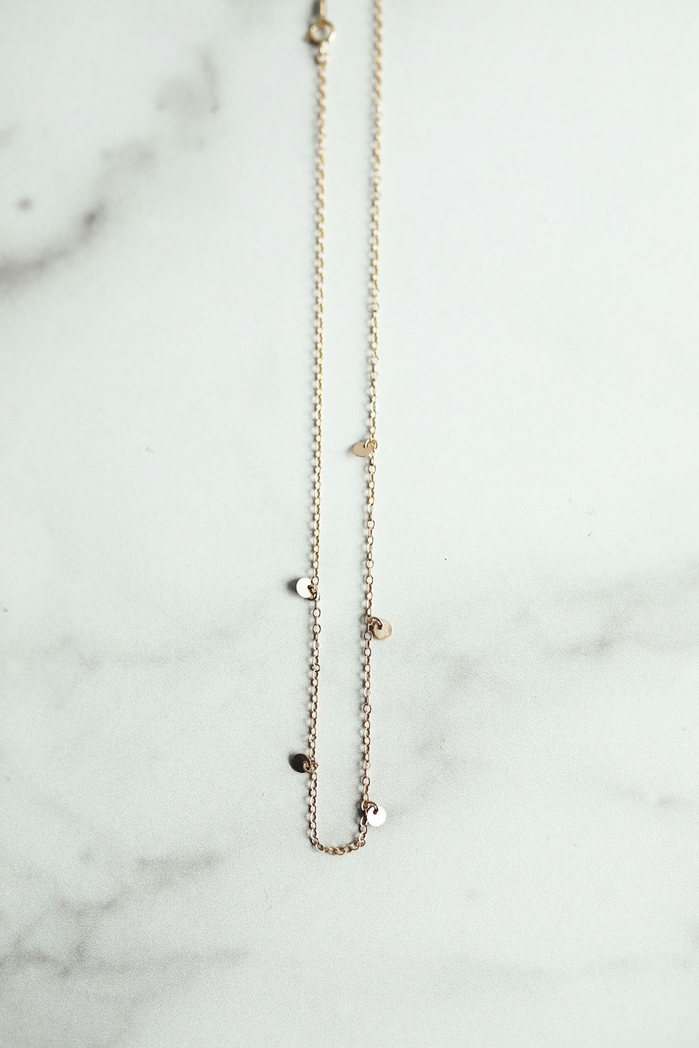gold chain on white snow