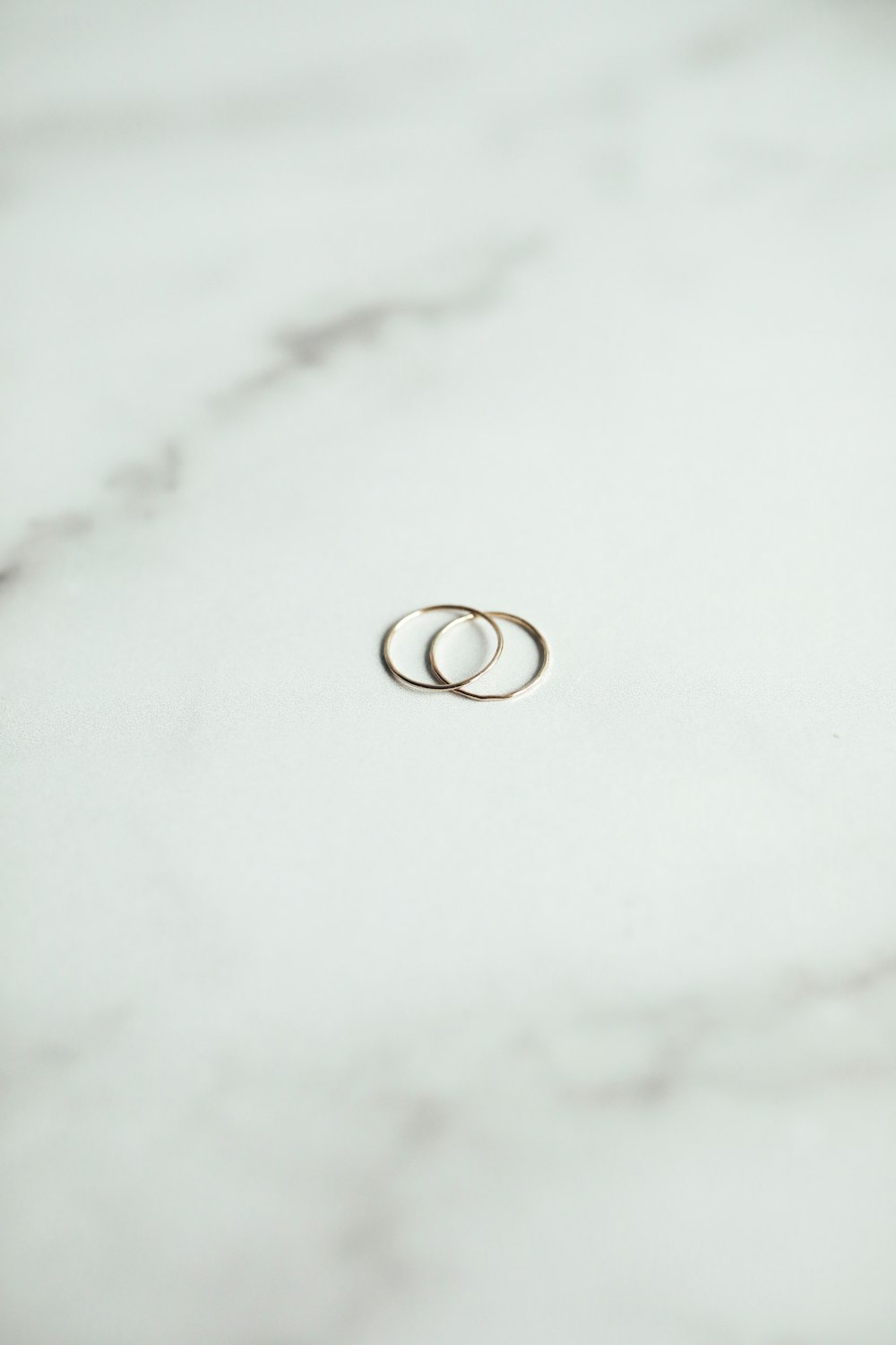 silver ring on white textile