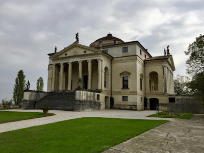 Grand entrance of Villa Anginette with exquisite architectural details and lush greenery.