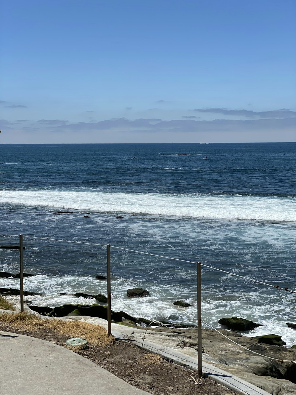 brown wooden fence on seashore during daytime