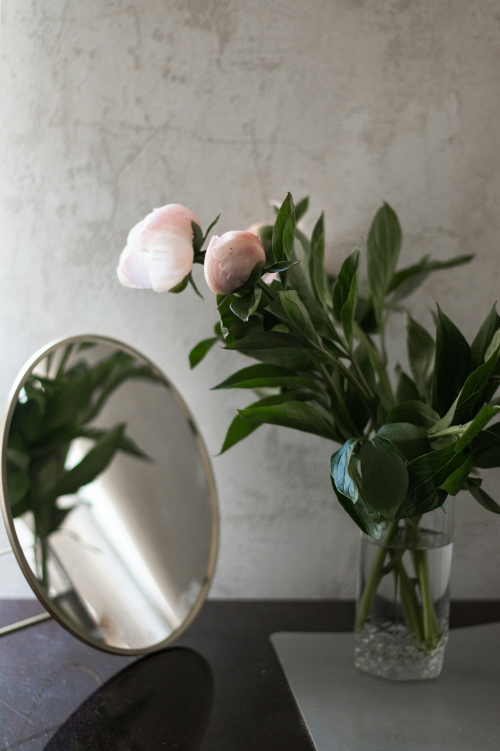 pink roses in green glass vase