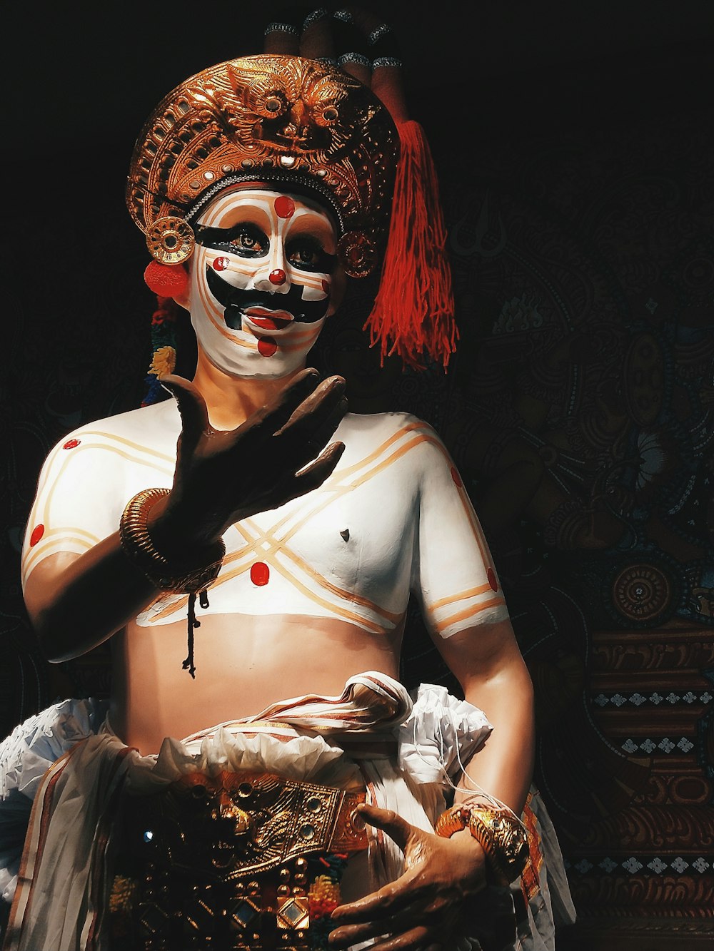 woman in white tank top with red and black face paint