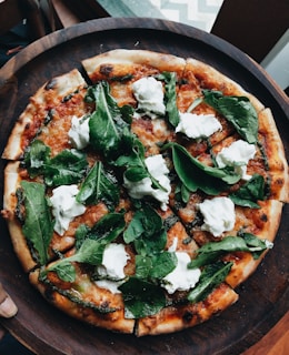 pizza with green leaves on top