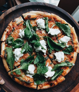 pizza with green leaves on top