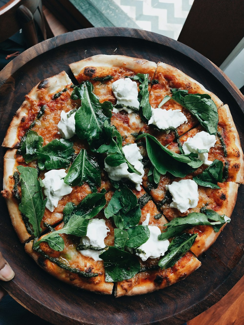 pizza with green leaves on top