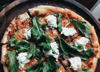 pizza with green leaves on top