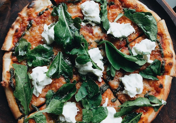 pizza with green leaves on top