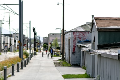 gray concrete road with cars parked beside