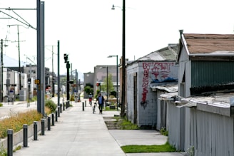 gray concrete road with cars parked beside