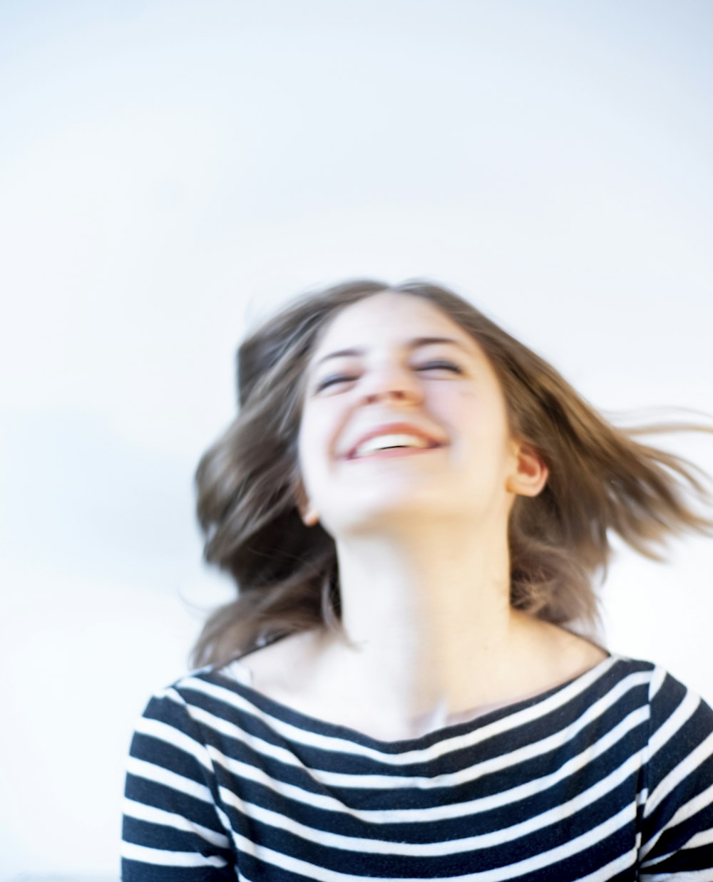 woman in white and black striped shirt