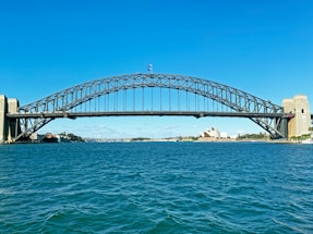 white bridge over the sea during daytime