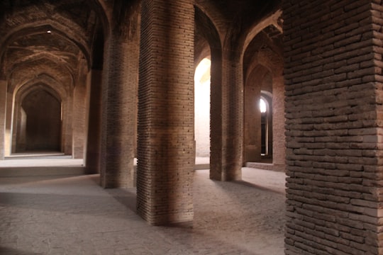 brown concrete hallway with lights turned on during daytime in Isfahan Iran