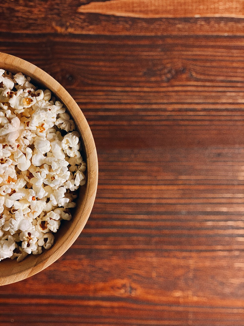 white popcorn on brown wooden bowl