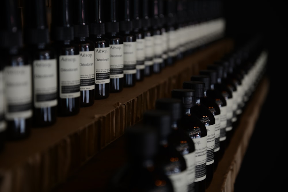 black and white bottles on brown wooden shelf