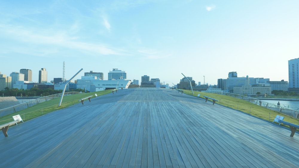 a wooden walkway in front of a city skyline