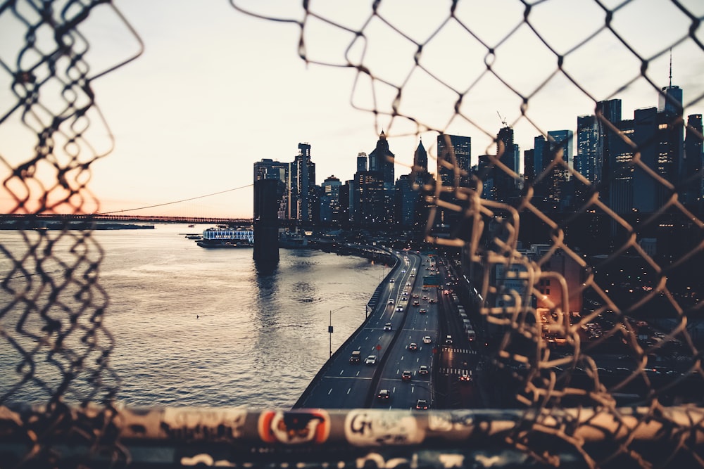 brown metal fence near body of water during daytime